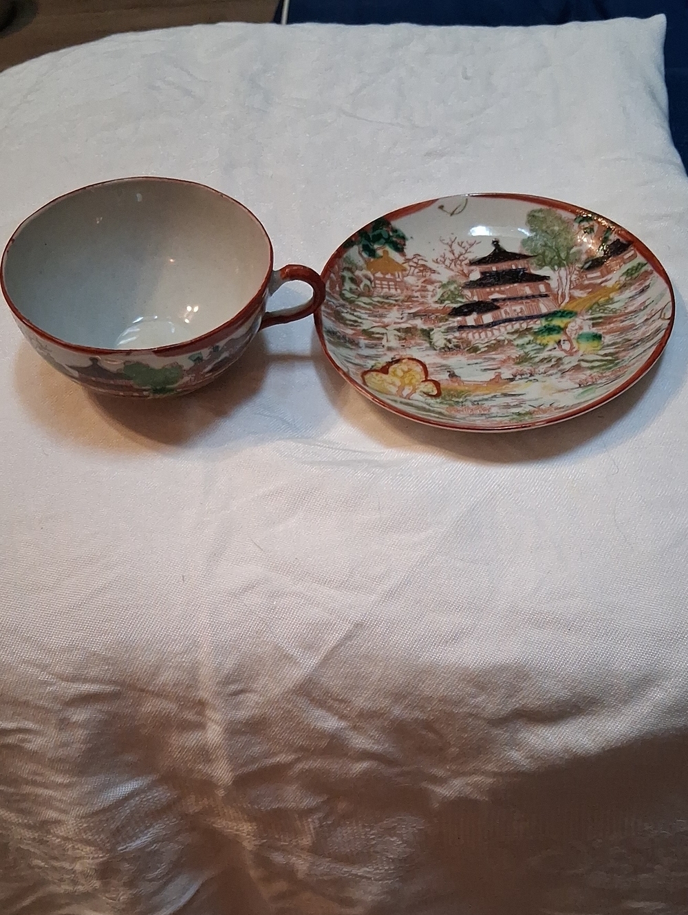 Antique cup and saucer set in white, red, green, gold